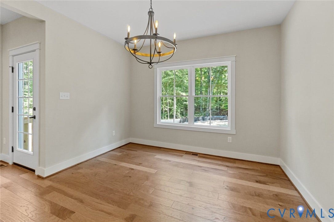 14270 Tower Road, Scotchtown Estates, Montpelier, VA 23047 Neutral-toned interior featuring wood-finish flooring, a multi-light metal chandelier, a large double-hung window, and a glass-paneled exterior door