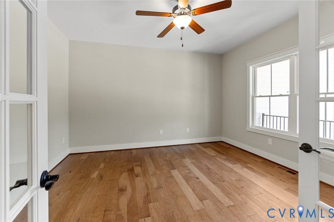 14270 Tower Road, Scotchtown Estates, Montpelier, VA 23047 Interior space featuring wood-finish flooring, double glass-paneled doors, multi-pane windows, and a central ceiling fan with an integrated light fixture