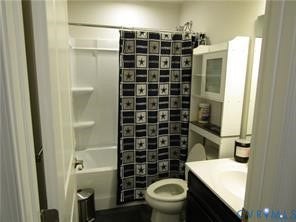 2210 Palm Court, Sandston, VA 23150 Bathroom featuring an integrated tub and shower unit, built-in shelving, and a vanity cabinet with a light-toned countertop