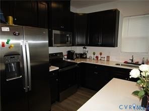 2210 Palm Court, Sandston, VA 23150 Kitchen featuring dark-finish cabinetry, stainless steel refrigerator, built-in microwave, and solid-surface countertops