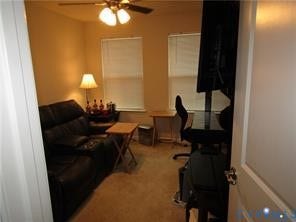 2210 Palm Court, Sandston, VA 23150 Room featuring neutral wall tones, carpeted flooring, two dual-pane windows with integrated blinds, and a ceiling-mounted light fixture with four-blade fan