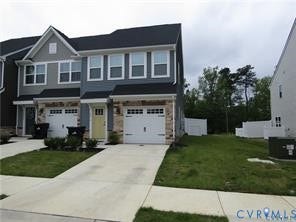 2210 Palm Court, Sandston, VA 23150 Multi-story exterior featuring stone veneer accents, lap siding, a shingled roof, and an integrated single-car garage