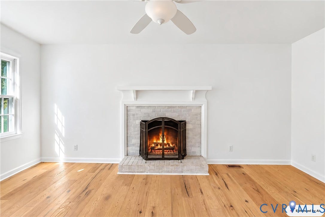 12506 Mandolin Drive, Chesterfield, VA 23113 Living area featuring wood-finish flooring, a masonry fireplace with a brick-surround hearth, a traditional mantel, and a ceiling-mounted fan