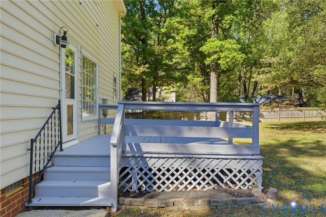 12506 Mandolin Drive, Chesterfield, VA 23113 Raised rear deck with painted wood railing, lattice skirting, and wrought-iron staircase handrail