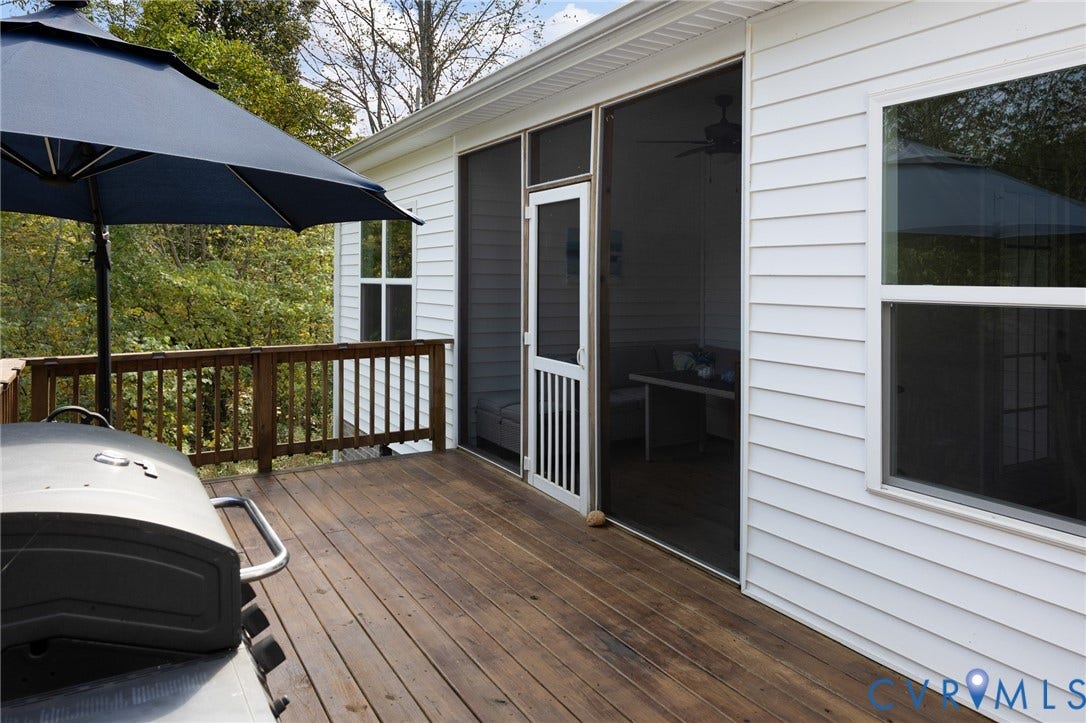 360 Anderson Mill Drive, Anderson Mill, Bumpass, VA 23024 Exterior wood deck featuring a wooden railing and a screened-in porch with a screen door and white lap siding