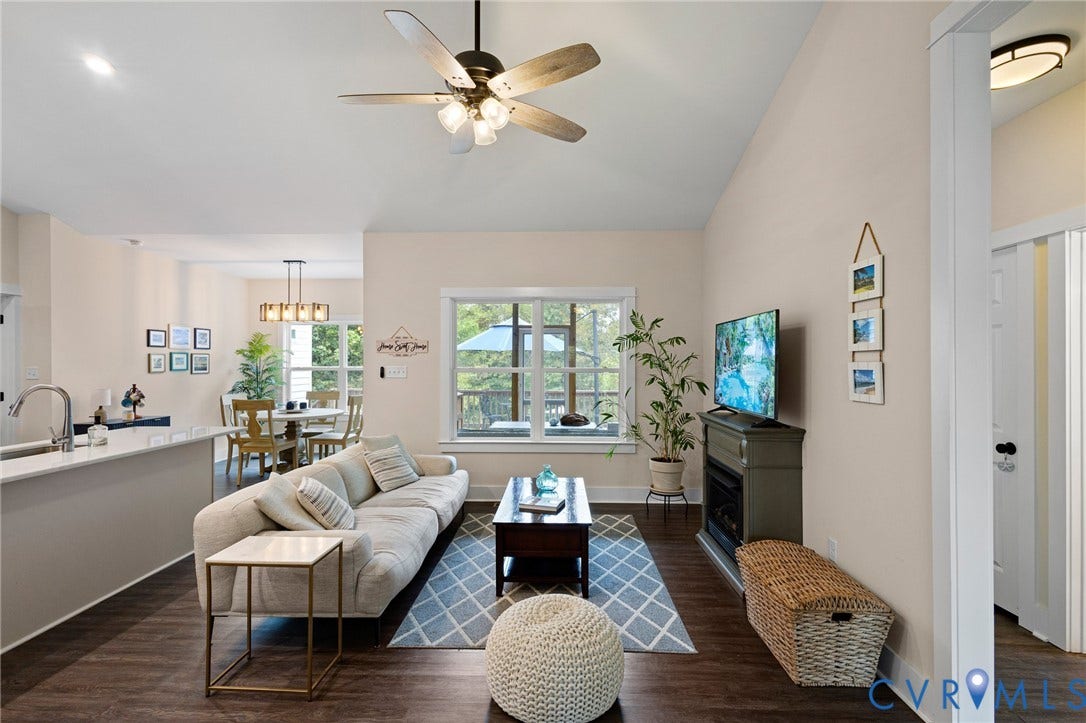 360 Anderson Mill Drive, Anderson Mill, Bumpass, VA 23024 Vaulted ceiling featuring a central multi-blade light fixture, wood-finish flooring, and built-in electric fireplace