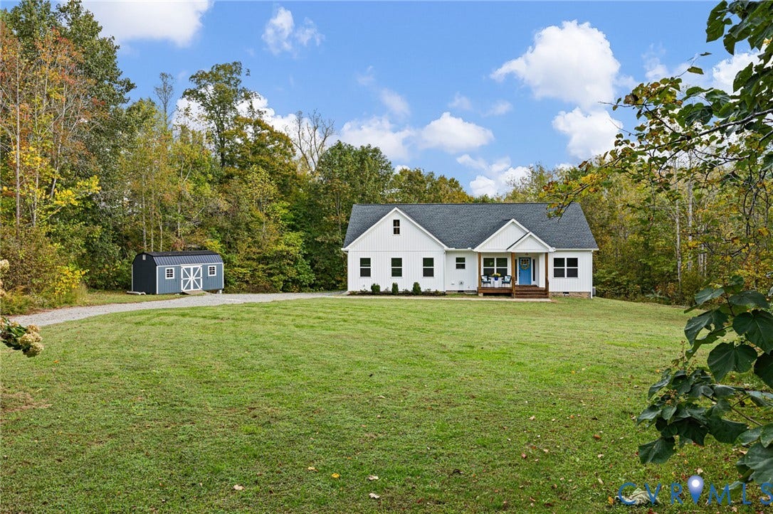 360 Anderson Mill Drive, Anderson Mill, Bumpass, VA 23024 Single-story residence featuring white siding, a shingled roof, a covered front porch, a gravel driveway, and an exterior storage shed situated on a grass lot