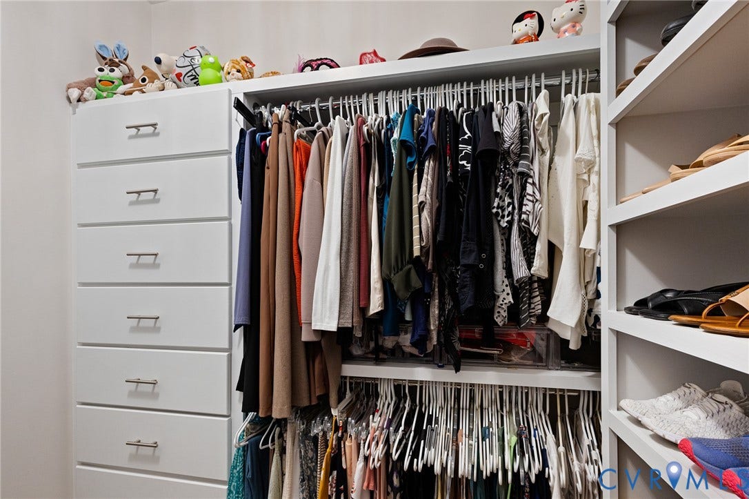 360 Anderson Mill Drive, Anderson Mill, Bumpass, VA 23024 Walk-in closet featuring white built-in cabinetry, floor-to-ceiling shelving, stainless steel hardware, and dual-level garment rods