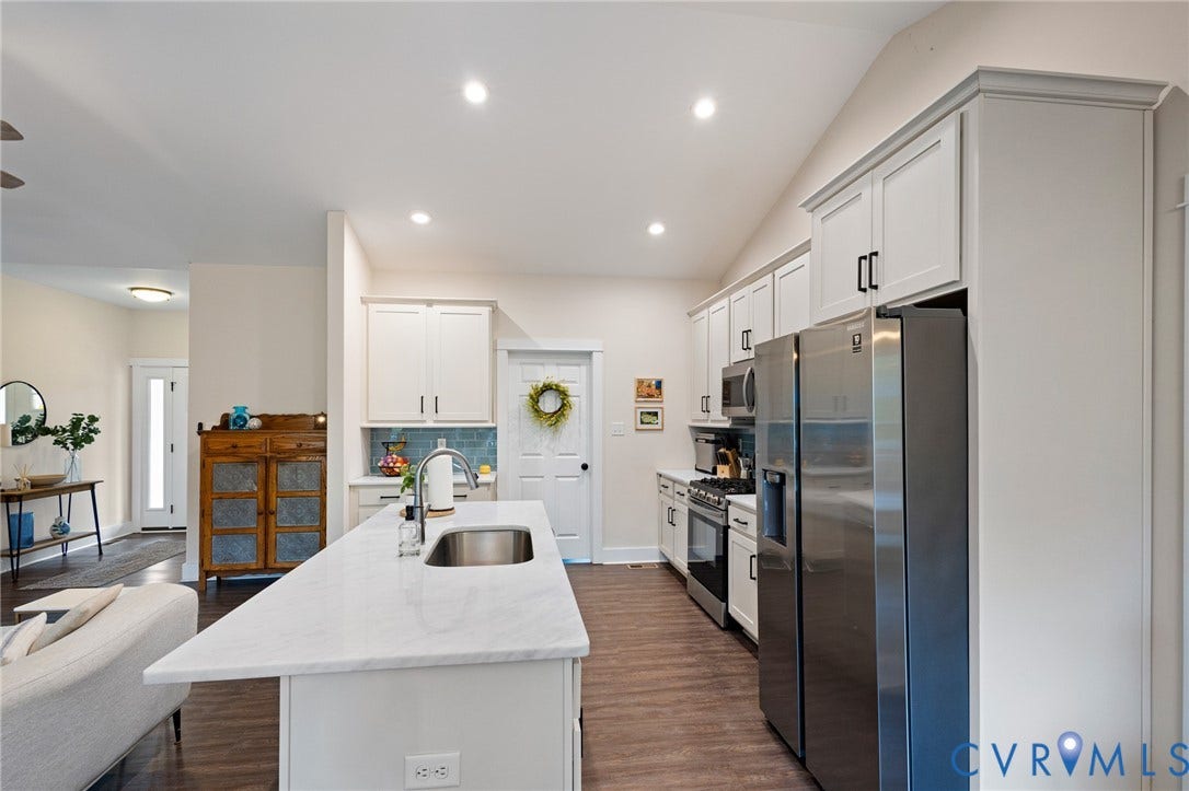 360 Anderson Mill Drive, Anderson Mill, Bumpass, VA 23024 Kitchen featuring an island with a stone-finish countertop and stainless steel undermount sink, white shaker-style cabinetry, stainless steel appliances, and wood-finish flooring