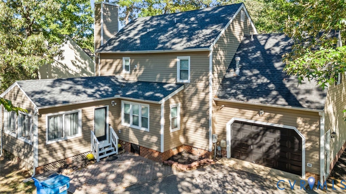 6500 Arbor Landing Drive, Arbor Landing, Chester, VA 23831 Two-story siding exterior featuring a brick foundation, asphalt shingle roof, attached single-car garage, and a brick-paved patio