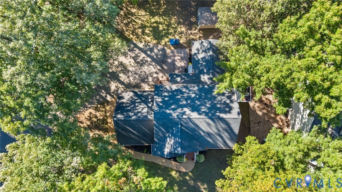 6500 Arbor Landing Drive, Arbor Landing, Chester, VA 23831 Aerial perspective of property featuring a shingled roof, paved driveway, brick-bordered walkway, and mature trees across a spacious lot