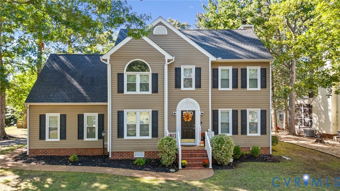 6500 Arbor Landing Drive, Arbor Landing, Chester, VA 23831 Two-story colonial exterior featuring vinyl siding, brick foundation accents, a multi-gabled roof, shuttered windows, and a brick-stepped entrance