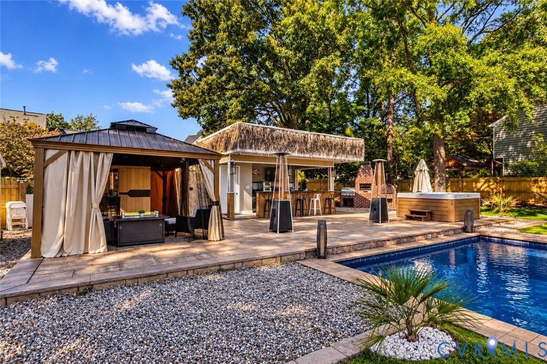 4504 Argonne Court, Glen Allen, VA 23060 *digitally enhanced to remove pool cover* Outdoor oasis featuring a paved stone patio, covered metal-roof gazebo, built-in outdoor kitchen, custom masonry fireplace, and in-ground swimming pool