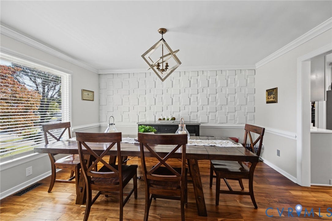 4504 Argonne Court, Glen Allen, VA 23060 Geometric textured accent wall, wood-finish flooring, crown molding, and a contemporary multi-light metal geometric chandelier