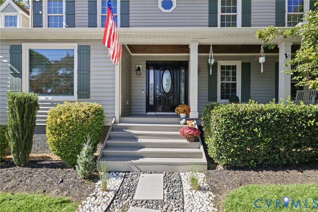 4504 Argonne Court, Glen Allen, VA 23060 Exterior facade with horizontal siding and dark shutters, front porch featuring square columns and wood-tone ceiling, and a decorative front door with an oval glass inset