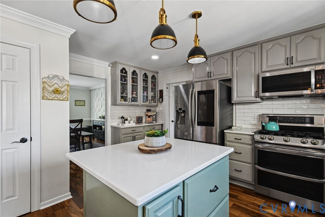 4504 Argonne Court, Glen Allen, VA 23060 Kitchen featuring custom cabinetry, a central island with a solid surface countertop, white subway tile backsplash, stainless steel appliances, and pendant lighting