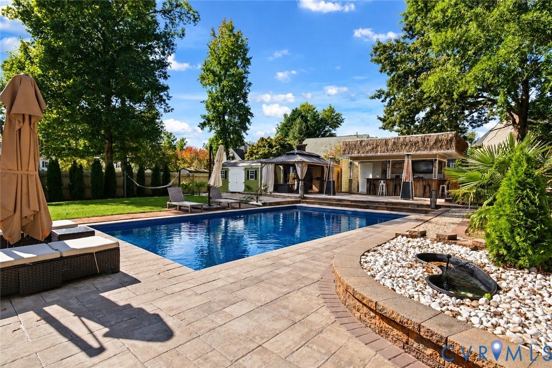 4504 Argonne Court, Glen Allen, VA 23060 *digitally enhanced to remove pool cover* In-ground swimming pool with stone paver decking, built-in poolside bar, raised stone water feature, and covered gazebo