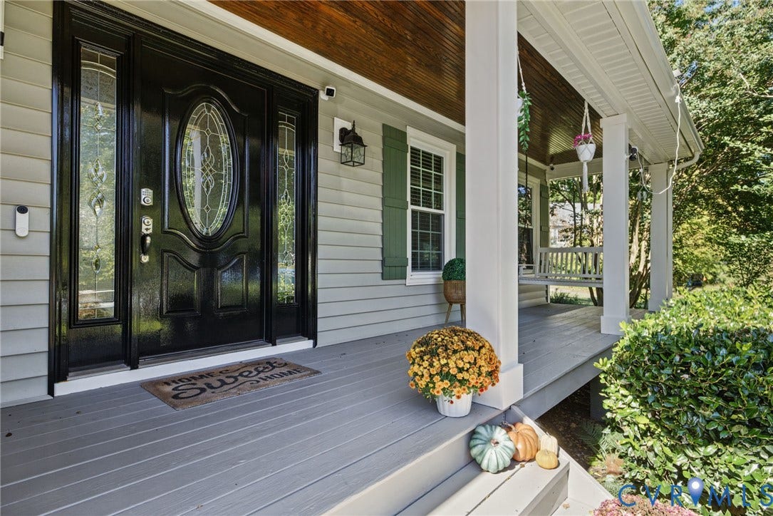 4504 Argonne Court, Glen Allen, VA 23060 Covered front porch featuring wood-plank ceiling, structural columns, lap siding, green shutters, and a front entry door with glass sidelights and oval window detailing