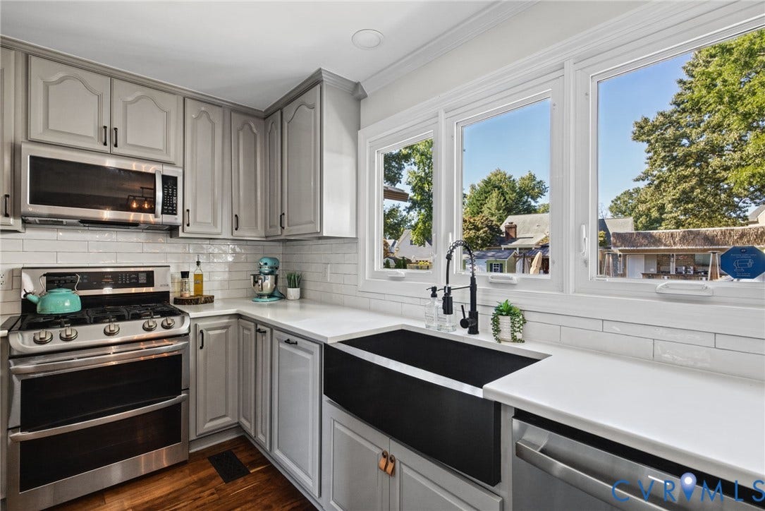 4504 Argonne Court, Glen Allen, VA 23060 Kitchen featuring soft-gray cabinetry, quartz countertops, white subway tile backsplash, stainless steel gas range with microwave, and a black apron-front sink with a matte black faucet