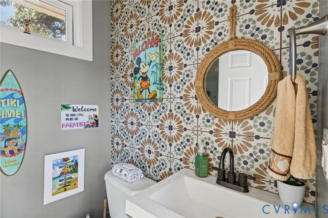 4504 Argonne Court, Glen Allen, VA 23060 Patterned ceramic tile accent wall, vessel sink with matte black faucet, and fixed transom window