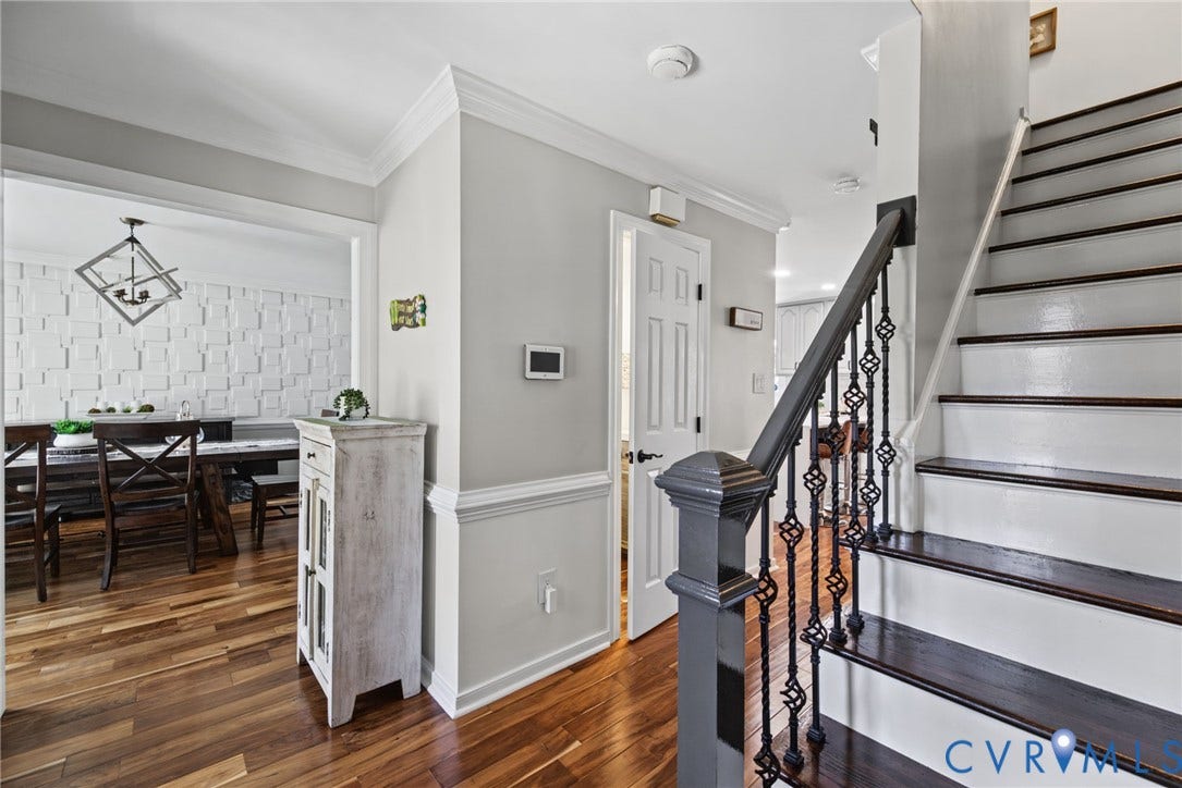 4504 Argonne Court, Glen Allen, VA 23060 Foyer featuring wood-finish flooring, staircase with dark-finished wood treads and metal balusters, crown molding, and wainscoting