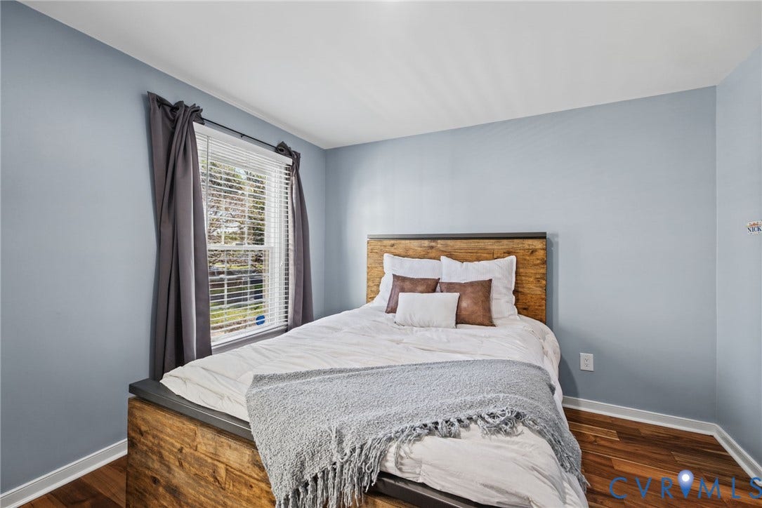 4504 Argonne Court, Glen Allen, VA 23060 Room featuring wood-finish flooring, light blue wall paint, and a single-pane window with horizontal blinds