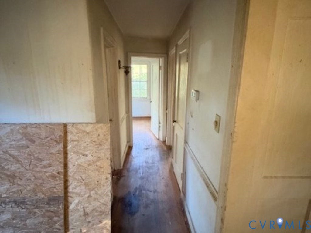 1330 Devers Road, Henrico, VA 23226 Hallway featuring wood-finish flooring, wainscoting, and a wall-mounted sconce
