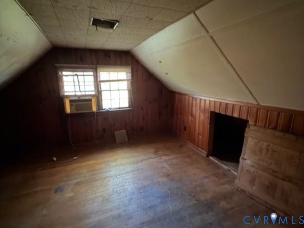 1330 Devers Road, Henrico, VA 23226 Attic space featuring wood-finish wall paneling, sloped ceilings, multi-pane windows, and wood-finish flooring