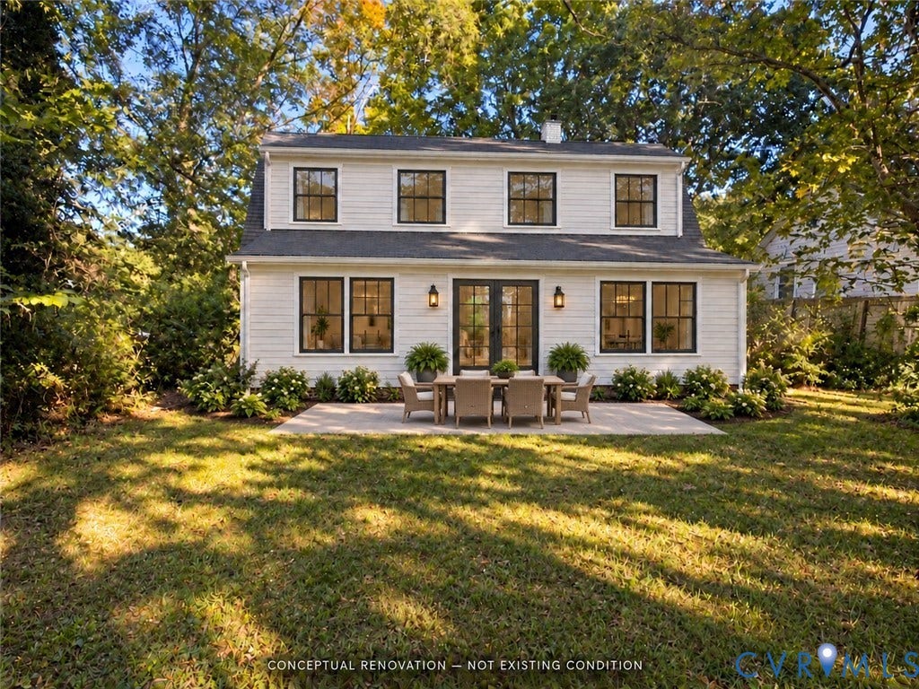 1330 Devers Road, Henrico, VA 23226 Two-story residence featuring light-toned horizontal siding, dark-trimmed grid windows, dual-panel glass French doors, and a stone patio