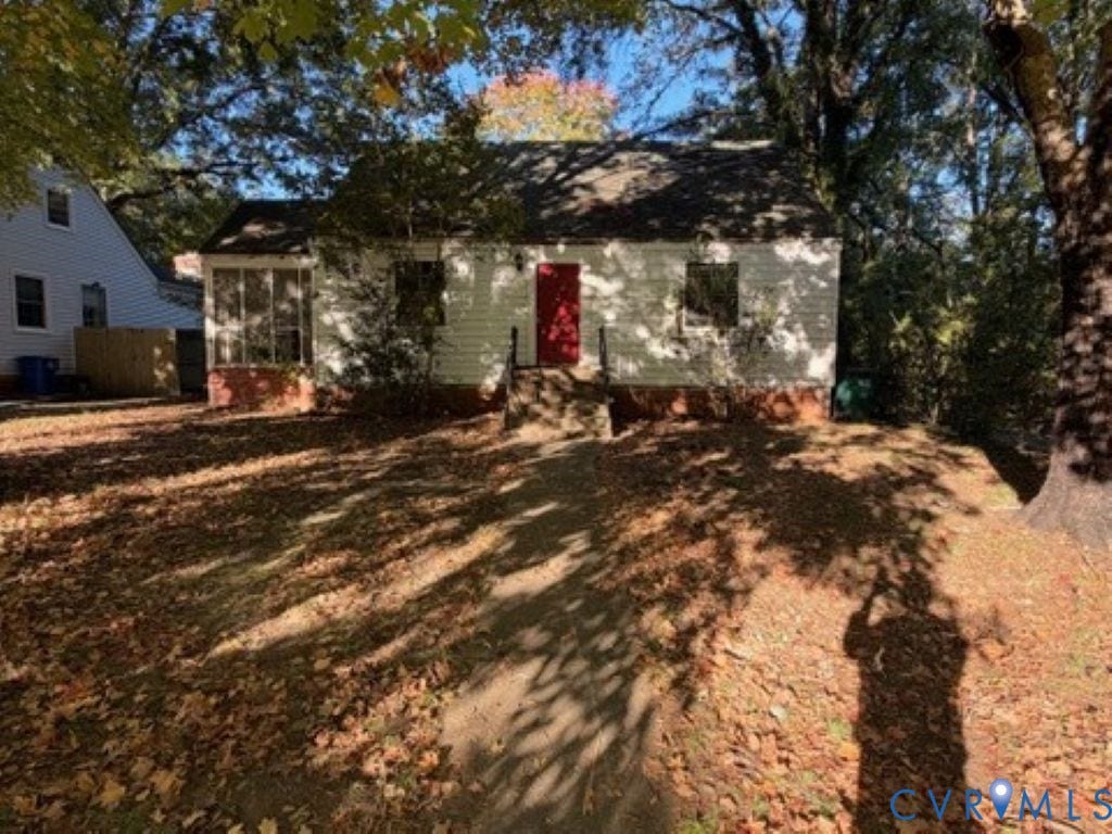1330 Devers Road, Henrico, VA 23226 Single-story residence featuring light-colored horizontal siding, a red front door, brick foundation, and an enclosed porch