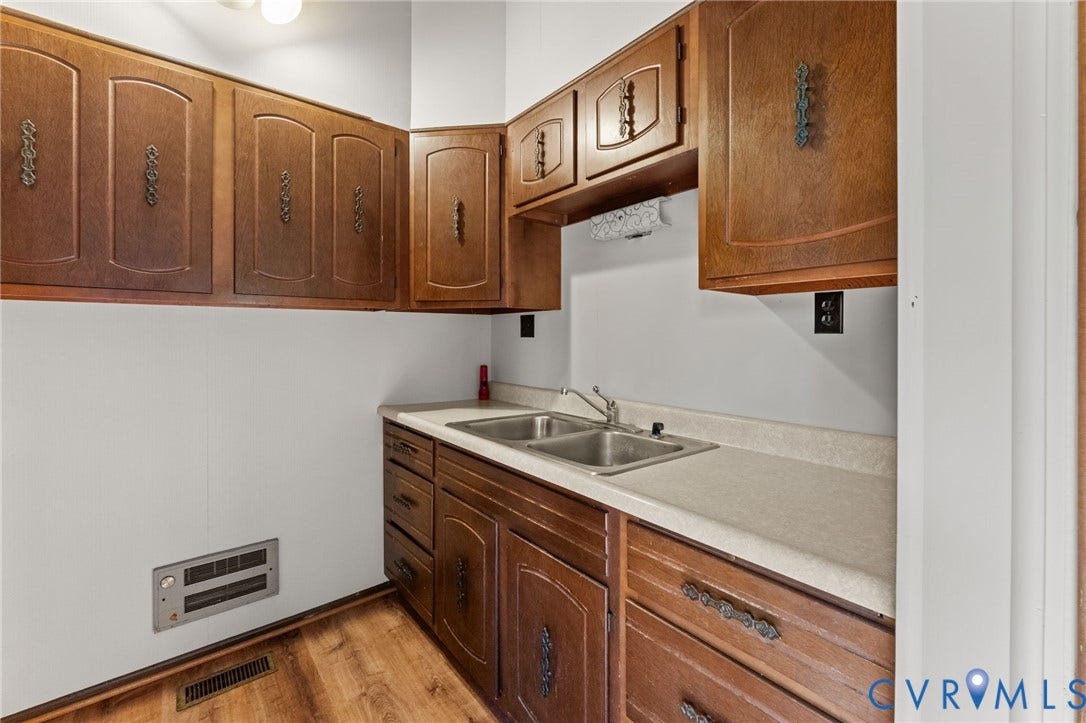 87 Pier Place, Town Of Kinsale, Kinsale, VA 22488 Kitchen has Double sinks, wood cabinets & laminate flooring.