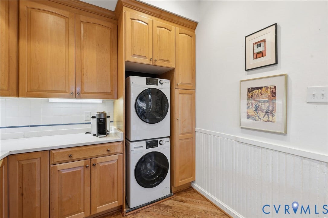 107 N Harvie Street, The Fan, Richmond, VA 23220 Laundry area featuring light-finish cabinetry, solid-surface countertops, beadboard wainscoting, and wood-finish flooring