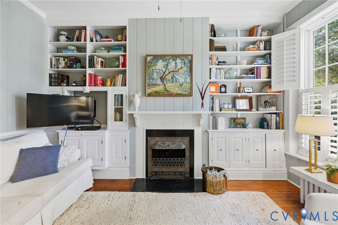 107 N Harvie Street, The Fan, Richmond, VA 23220 Fireplace with a metal insert and dark hearth flanked by floor-to-ceiling built-in cabinetry with integrated shelving and base cabinets