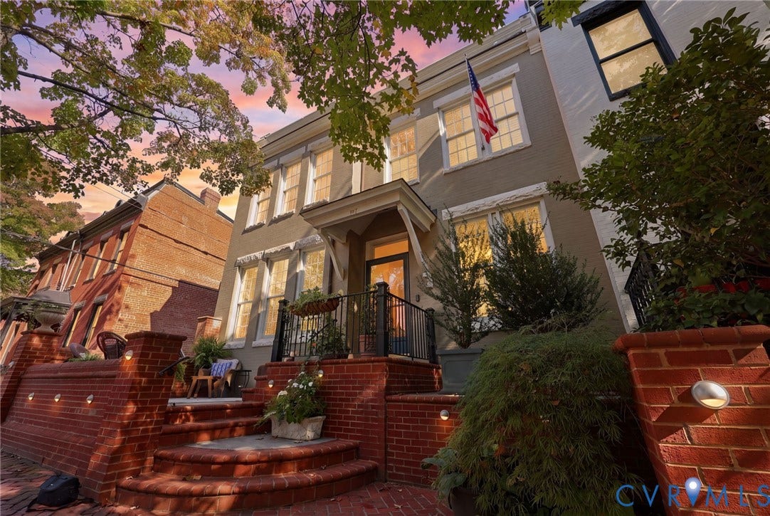 107 N Harvie Street, The Fan, Richmond, VA 23220 Brick exterior facade featuring a covered entryway, elevated porch with metal railings, and tiered red brick stairs