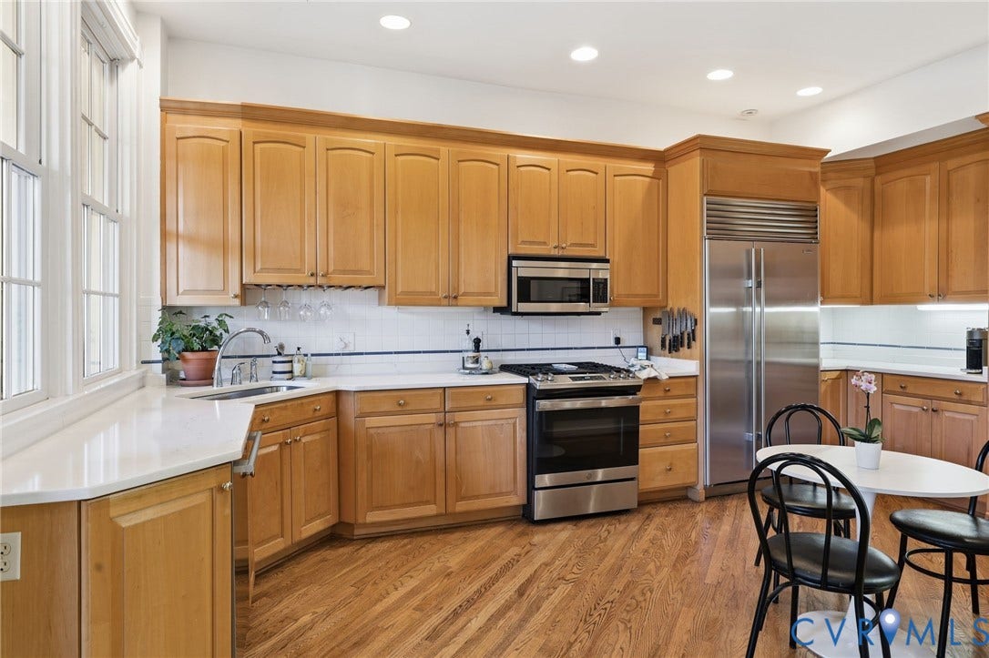 107 N Harvie Street, The Fan, Richmond, VA 23220 Kitchen featuring custom wood cabinetry, stainless steel professional-grade refrigerator, gas range, recessed lighting, and wood-finish flooring