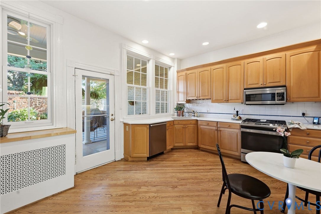 107 N Harvie Street, The Fan, Richmond, VA 23220 Kitchen featuring wood cabinetry, stainless steel appliances, wood-finish flooring, recessed lighting, and multi-pane windows