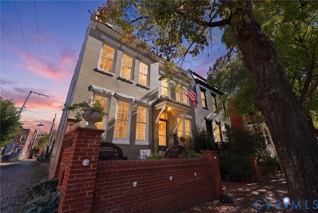 107 N Harvie Street, The Fan, Richmond, VA 23220 Three-story masonry exterior featuring a front brick terrace, multi-pane windows, and a covered entryway