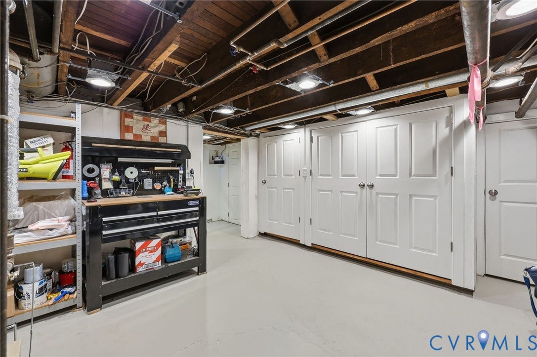 107 N Harvie Street, The Fan, Richmond, VA 23220 Utility area featuring an epoxy-coated concrete floor, exposed wood-joist ceiling, recessed lighting, and multiple interior six-panel doors