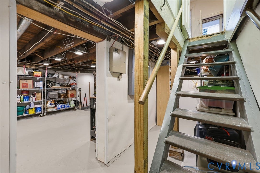 107 N Harvie Street, The Fan, Richmond, VA 23220 Unfinished lower level featuring exposed wood joist ceilings, concrete flooring, and a wooden staircase