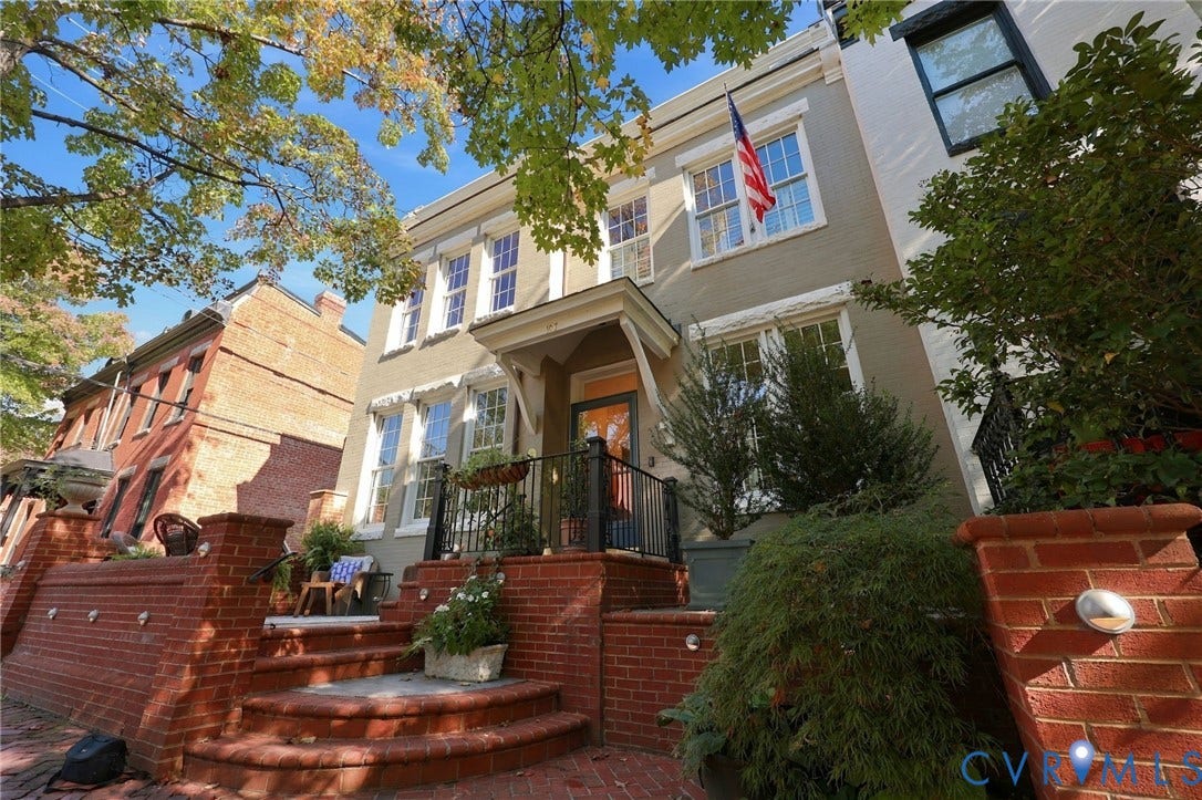 107 N Harvie Street, The Fan, Richmond, VA 23220 Painted brick exterior featuring a prominent covered entry portico, tiered brick masonry steps, and custom black metal railings