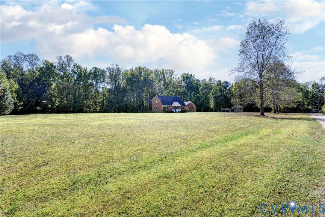 14151 Black Horse Lane, Lanexa, VA 23089 Expansive acreage featuring open green space, mature tree lines, and a brick exterior residence