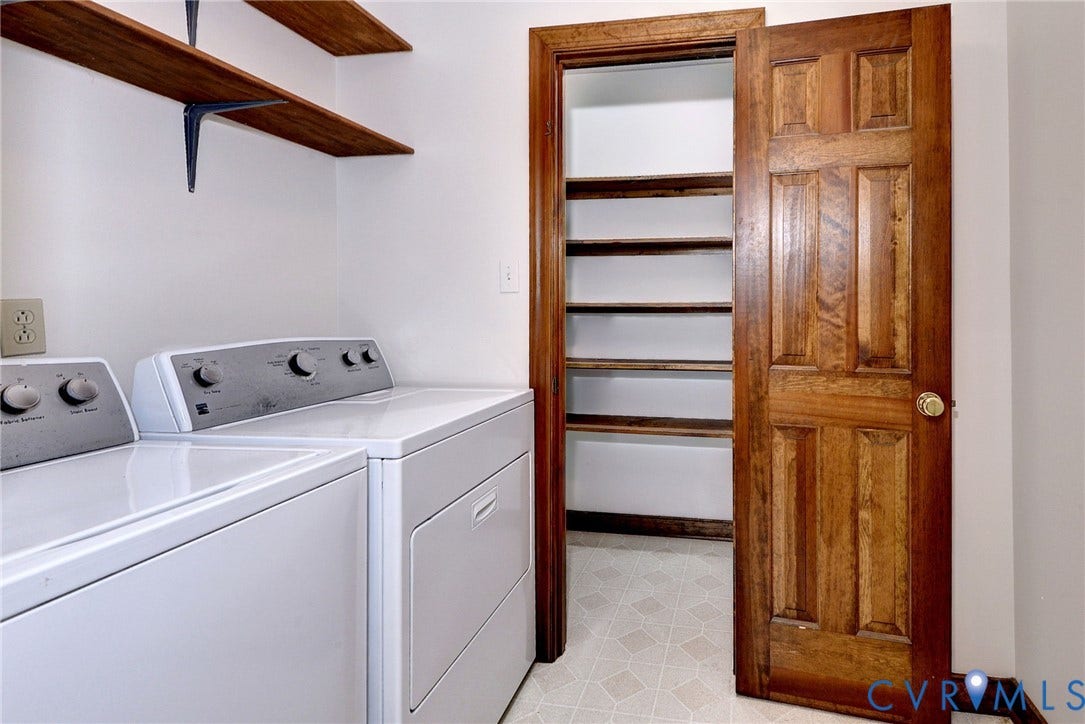 14151 Black Horse Lane, Lanexa, VA 23089 Utility room featuring wall-mounted wood shelving, a six-panel wood door, and a built-in pantry with multiple tiers of shelving