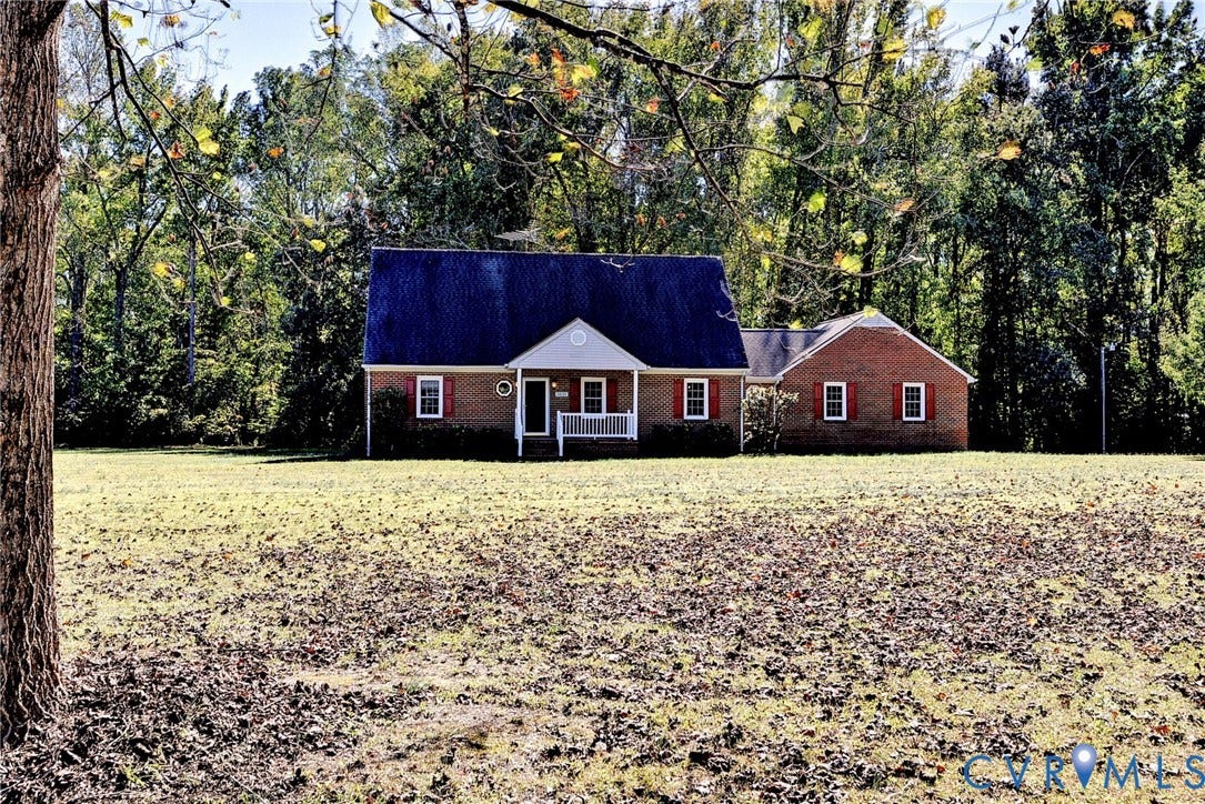 14151 Black Horse Lane, Lanexa, VA 23089 Brick exterior residence featuring a front porch, gabled roofline, decorative shutters, and expansive acreage