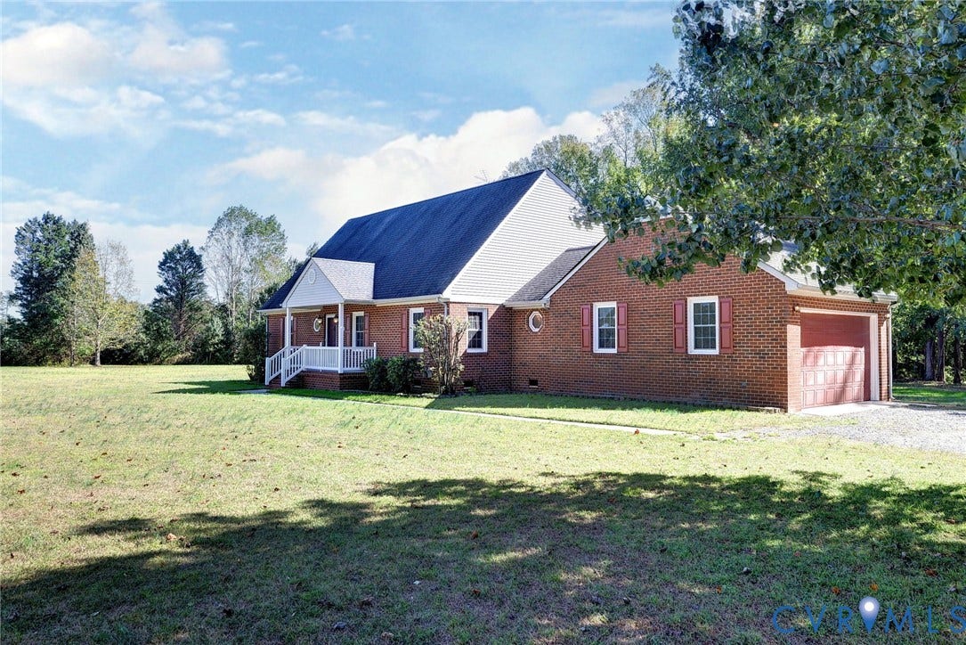 14151 Black Horse Lane, Lanexa, VA 23089 Traditional brick exterior featuring a covered front porch, attached garage, gabled roofline, and expansive grounds