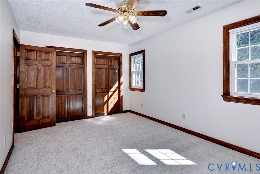 14151 Black Horse Lane, Lanexa, VA 23089 Neutral carpeting, natural wood-finish interior doors and trim, double-hung windows, and a ceiling fan with integrated lighting