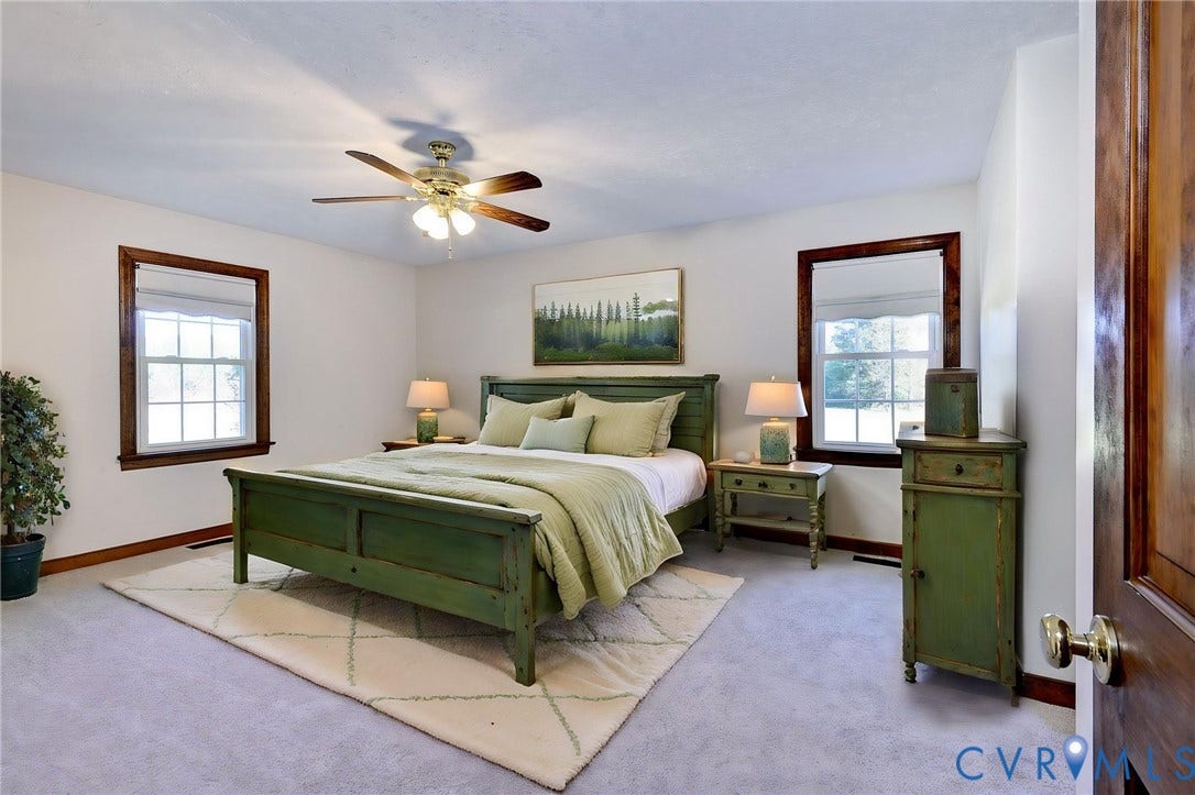 14151 Black Horse Lane, Lanexa, VA 23089 VIRTUAL STAGING - Dual windows with dark wood trim, integrated ceiling fan with light fixture, and solid wood interior door