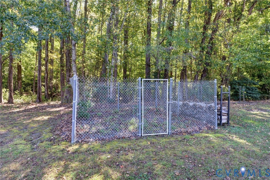 14151 Black Horse Lane, Lanexa, VA 23089 Chain-link perimeter fencing surrounding a natural lot with mature tree growth