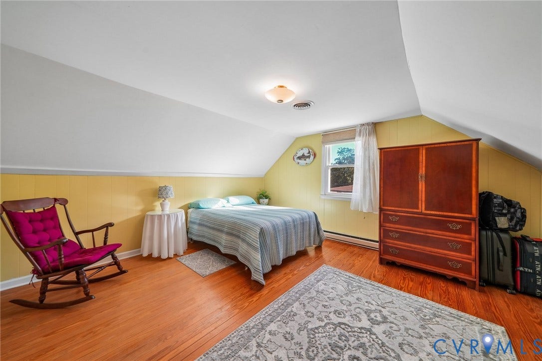 3030 Brentwood Circle, Chesterfield, VA 23237 Bedroom featuring slanted ceilings, wood-finish flooring, and natural light from a single window