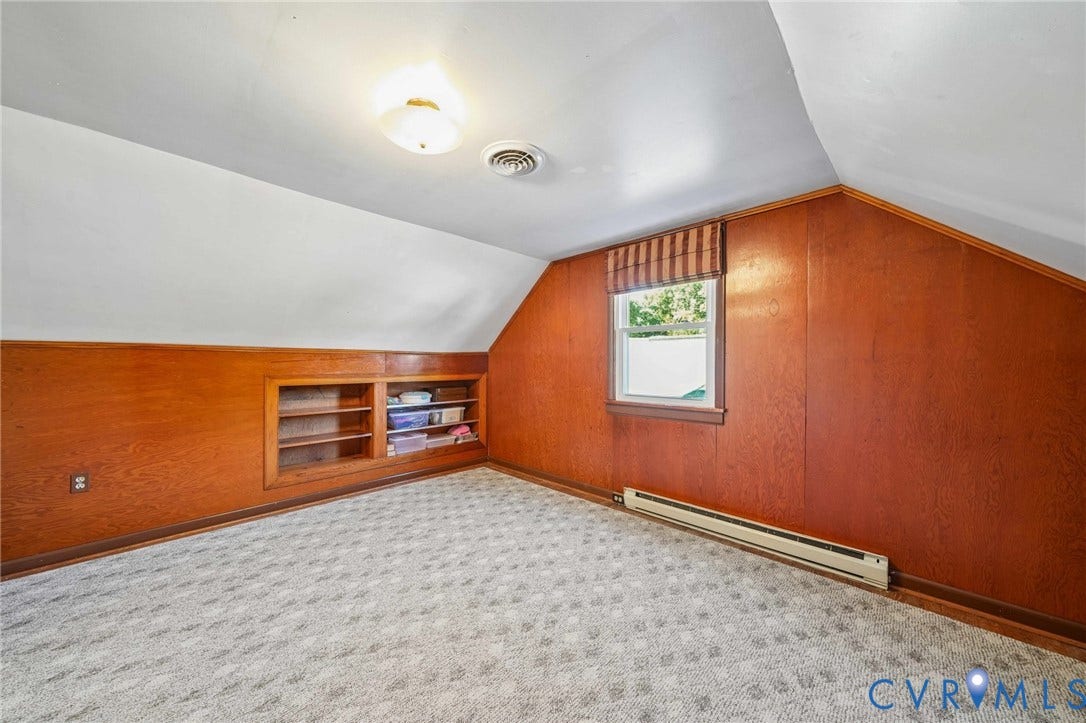 3030 Brentwood Circle, Chesterfield, VA 23237 Room featuring wood-panelled walls, built-in recessed shelving, patterned wall-to-wall carpeting