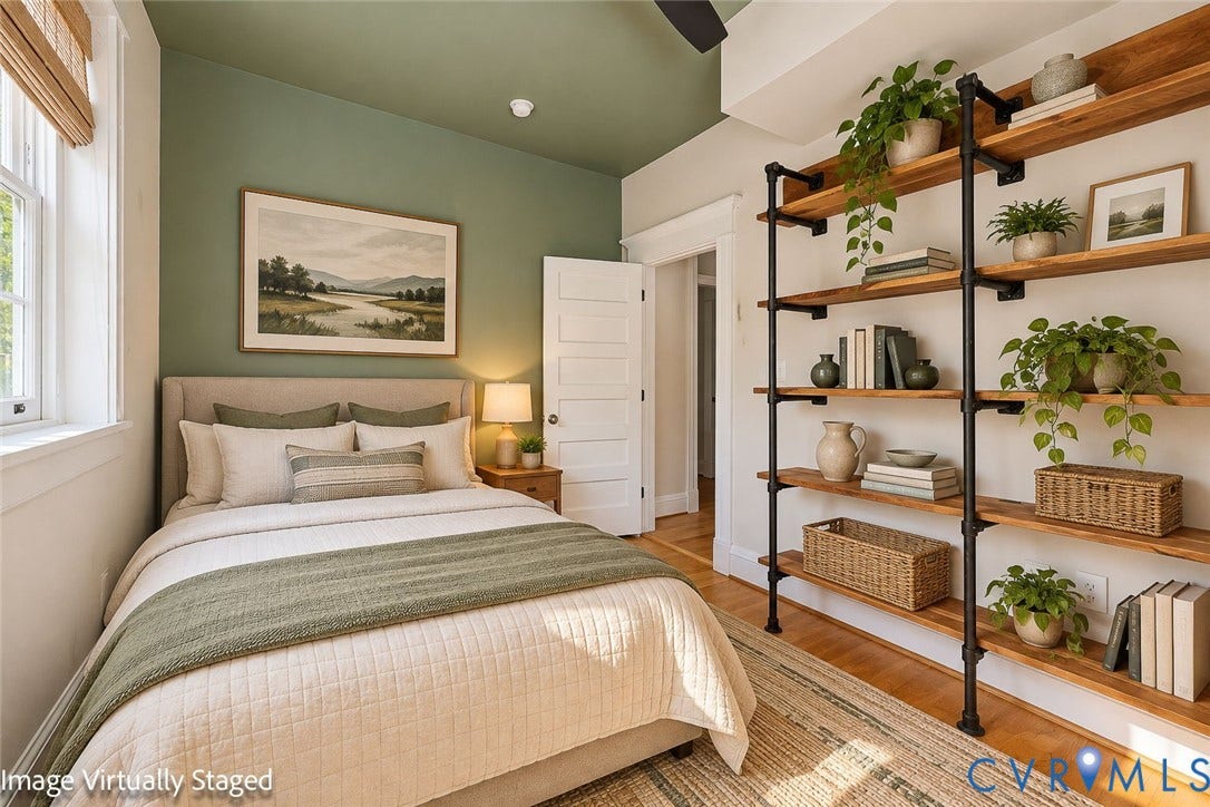 101 N Stafford Avenue, #U4, Stafford Terrace Condo, Richmond, VA 23220 Built-in floor-to-ceiling industrial-style shelving featuring dark metal pipe supports and natural wood-finish shelving, accented by a deep olive-green ceiling and wall color, traditional five-panel interior door, and hardwood flooring